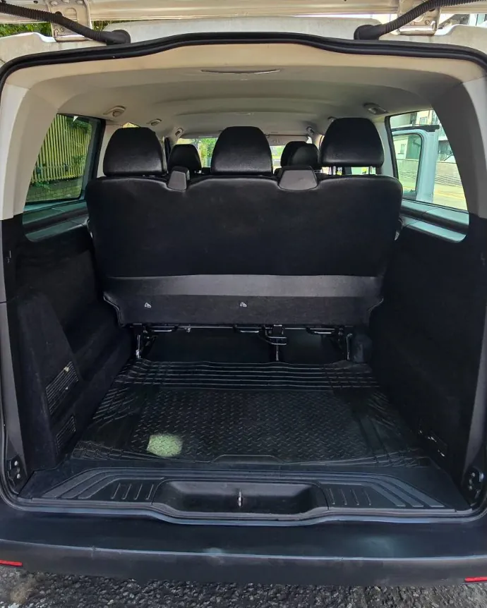 Open boot of the 8-seater van showing the separate luggage compartment behind the rear seats