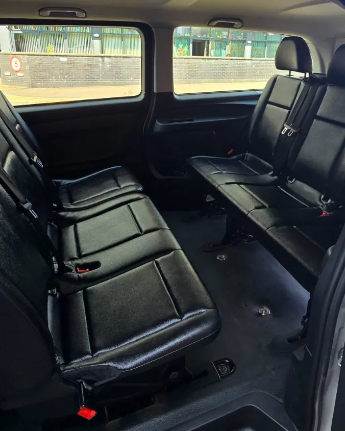 Rear seating rows inside the 8-seater van, each seat with its own three-point seatbelt